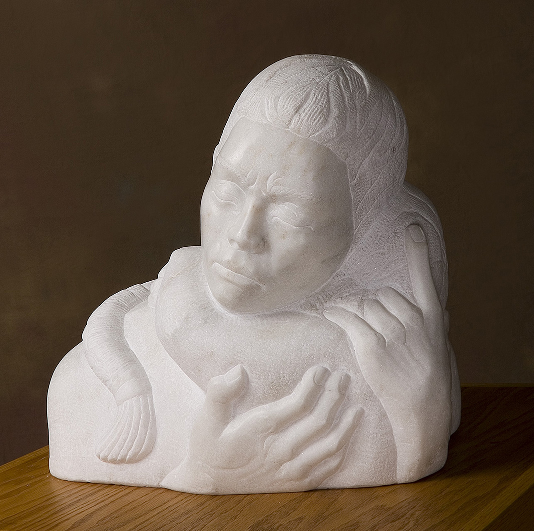 Loved and Life" marble sculpture depicting a woman holding a child, hand carved from Carrara marble by a skilled stone carver. This custom-made, three-dimensional portrait sculpture showcases traditional stone carving techniques using hammer and chisel. A fine example of in the round marble sculpture, blending emotion and craftsmanship, available at Stone Revival Gallery + Gift Shop in Vermont.